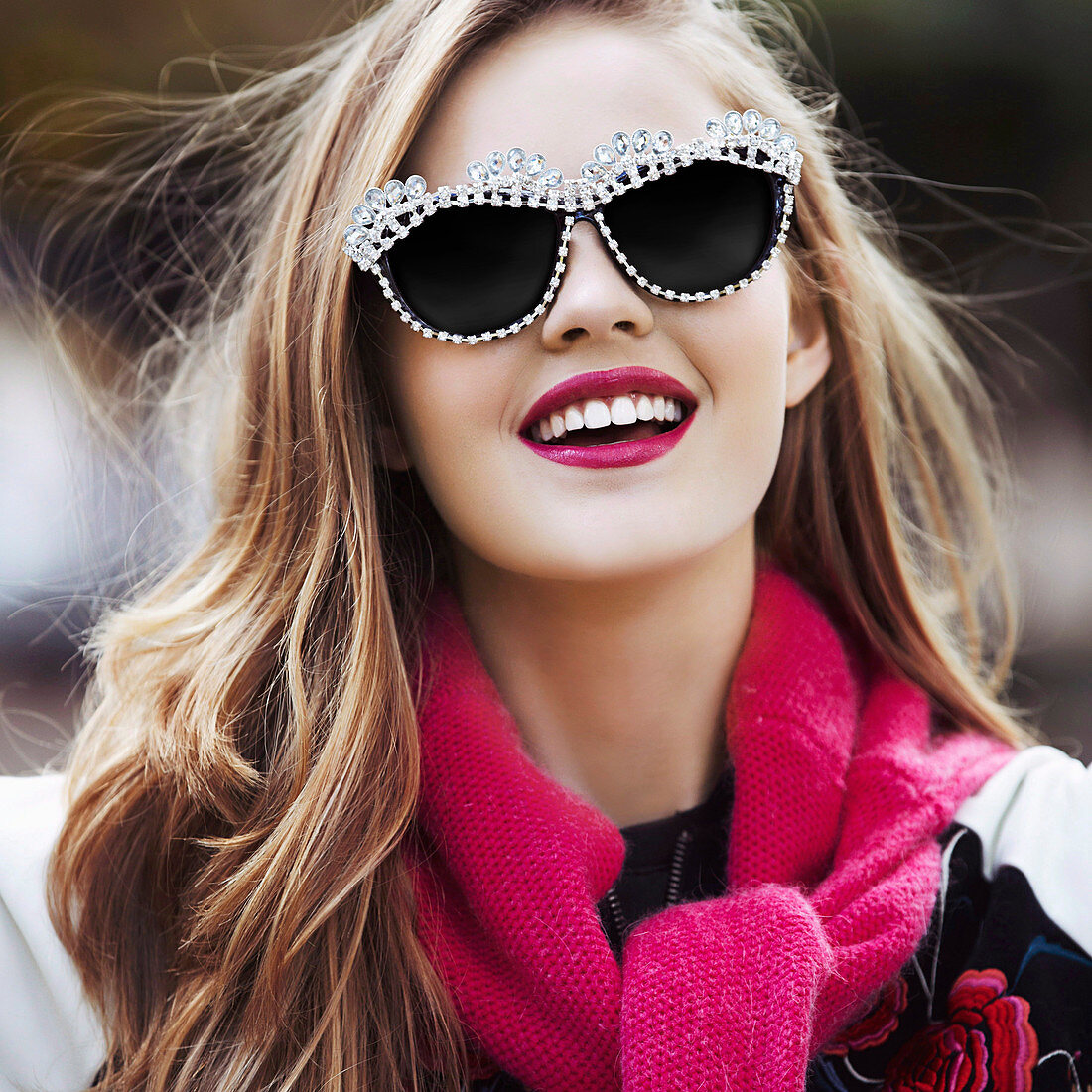 A young woman with lipstick and sunglasses