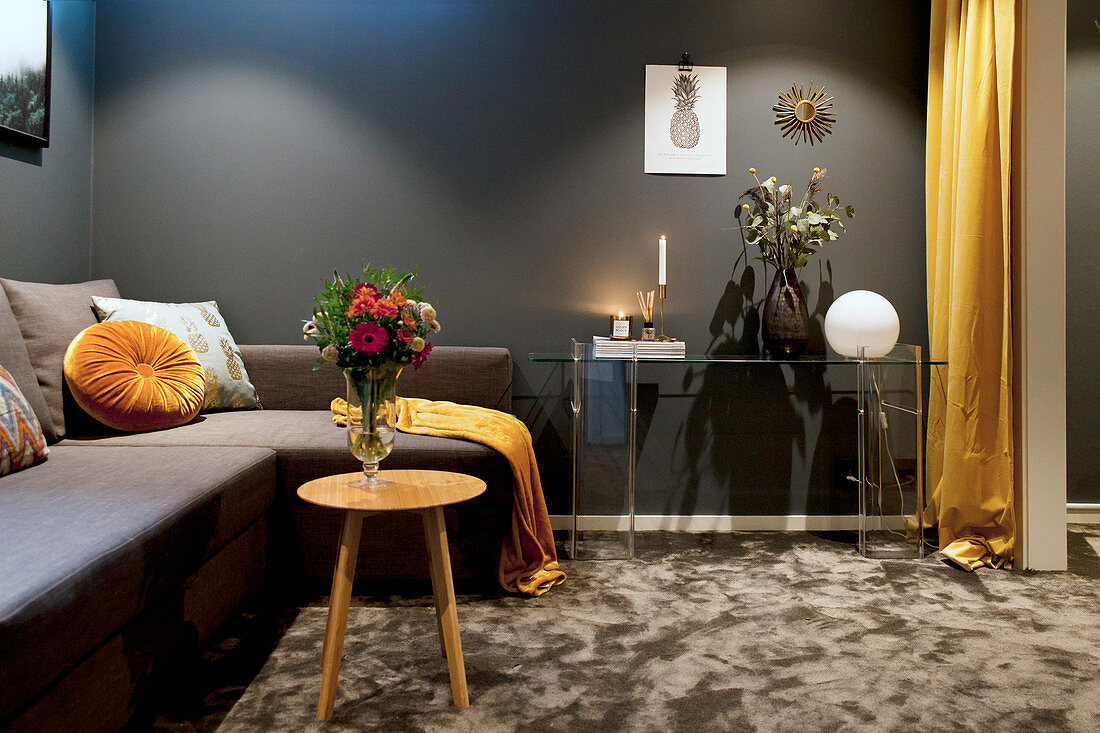 Dark living room in shades of grey and ochre