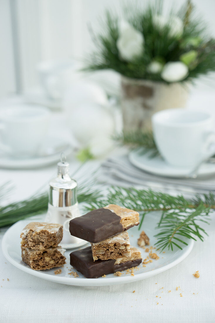 Basler Leckerli (hard spiced biscuit from Basel, Switzerland) and Christmas decorations on a plate