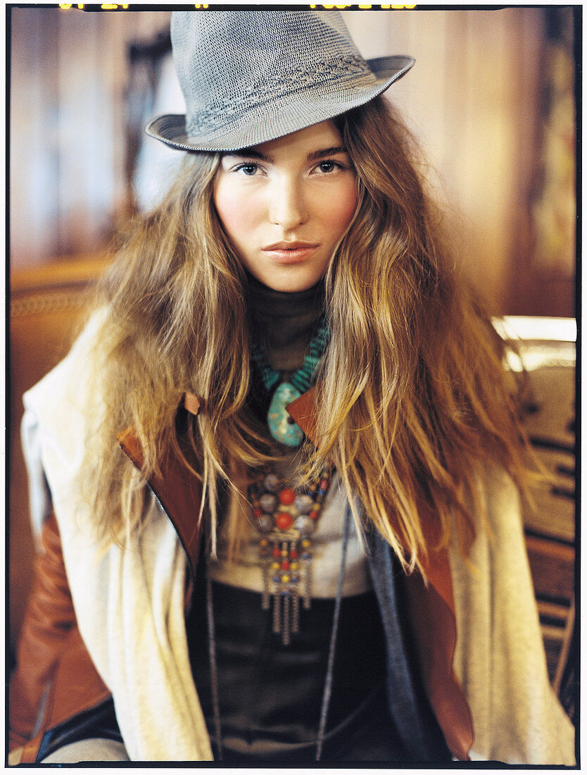 A young woman wearing a grey hat