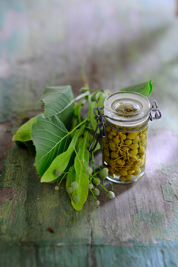 Pickled linden capers in a flip-top jar