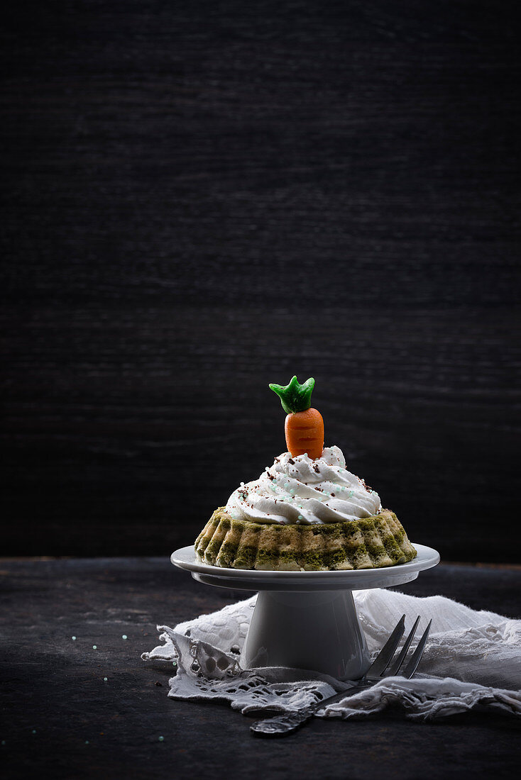 Vegan matcha vanilla cake with a marzipan carrot