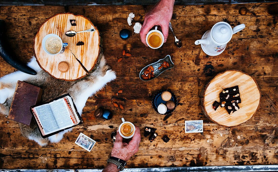 A coffee table laid with brownies and macarons