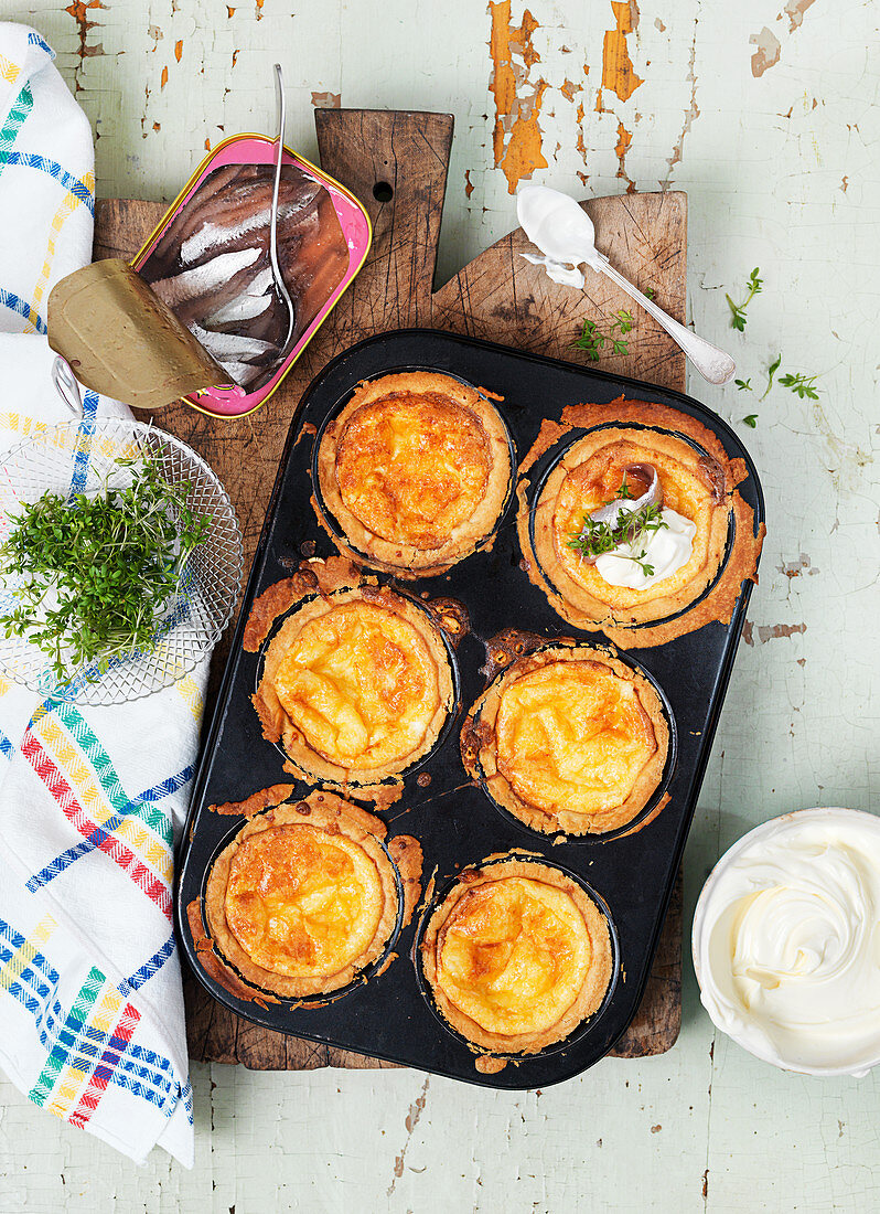 Cheese pastries with anchovies, sour cream and cress