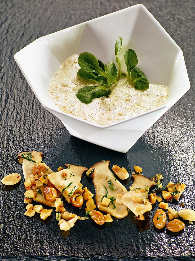 Jerusalem artichoke soup with almonds, grapes and porcini mushrooms