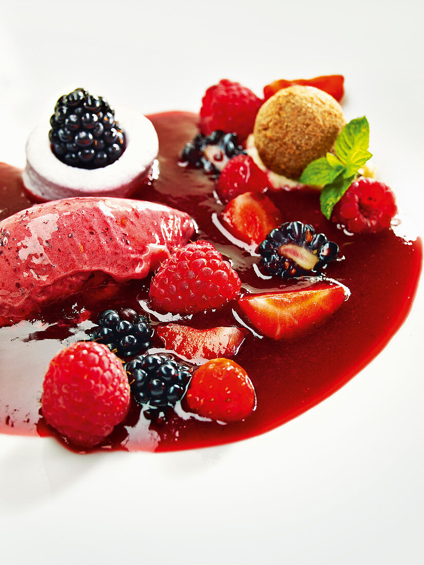 Strawberry sorbet with red berry sauce