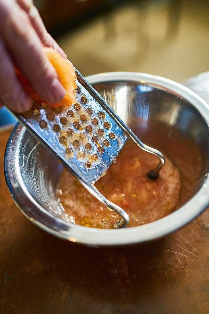 Grating a blood orange filet