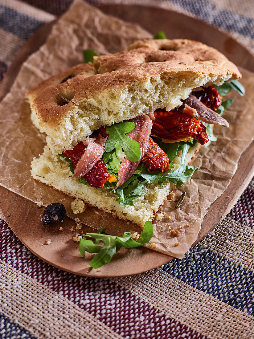 Focaccia with tomato, olives and rocket