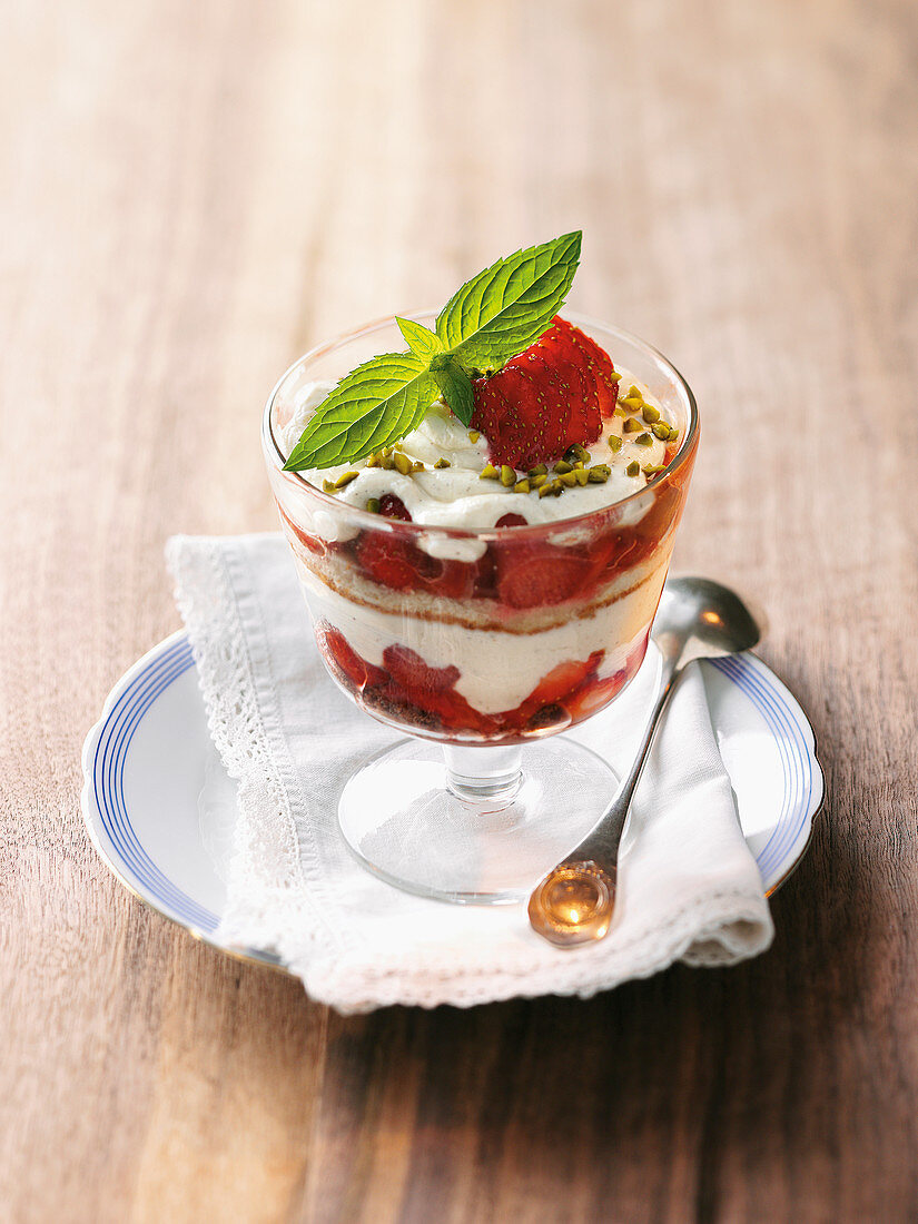 Strawberry and rhubarb sponge cake with pistachio nuts in a glass