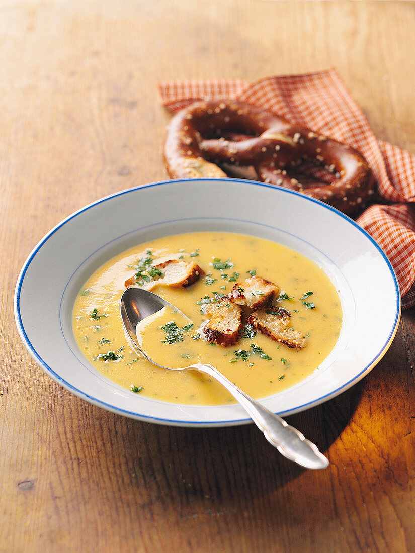 Country cheese soup with pretzel croutons