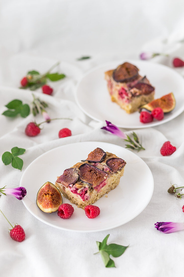 Slices of a baked millet with figs and raspberries