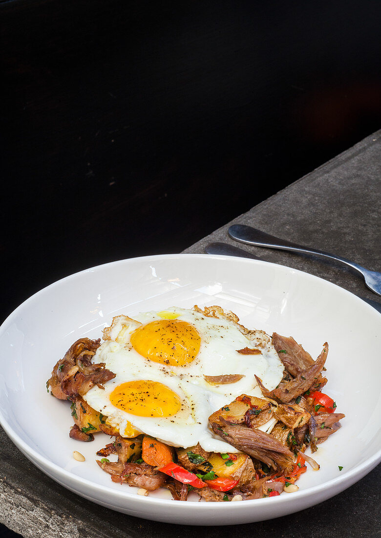 Duck hash with sunny side up eggs