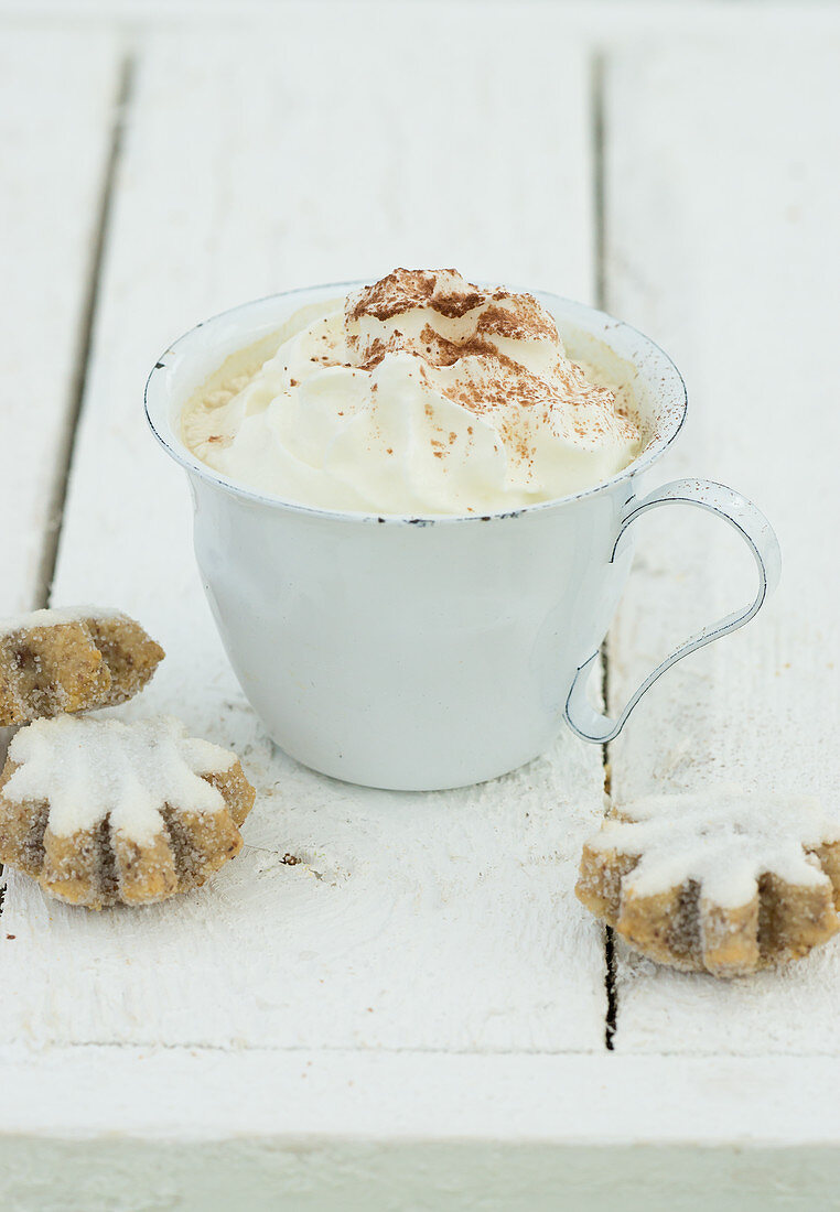 Hot chocolate with cream and cinnamon biscuits