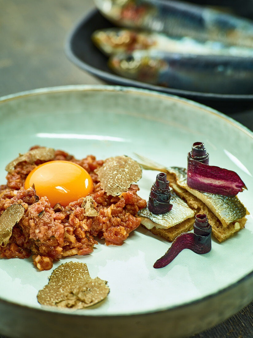 Beef tartare with truffles, anchovies and purple carrots