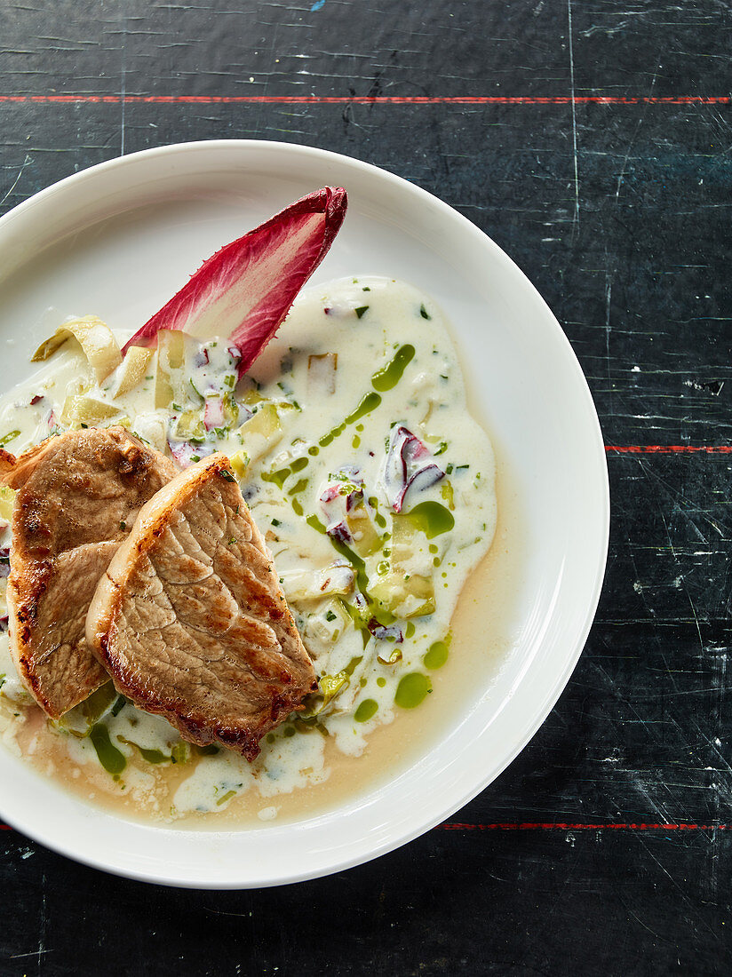 Pork chop with colourful chicory and tarragon oil