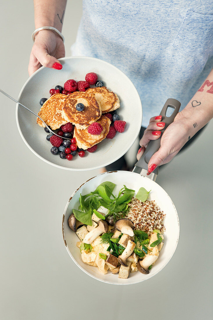 Protein pancakes with berries and scrambled eggs with king trumpet mushrooms