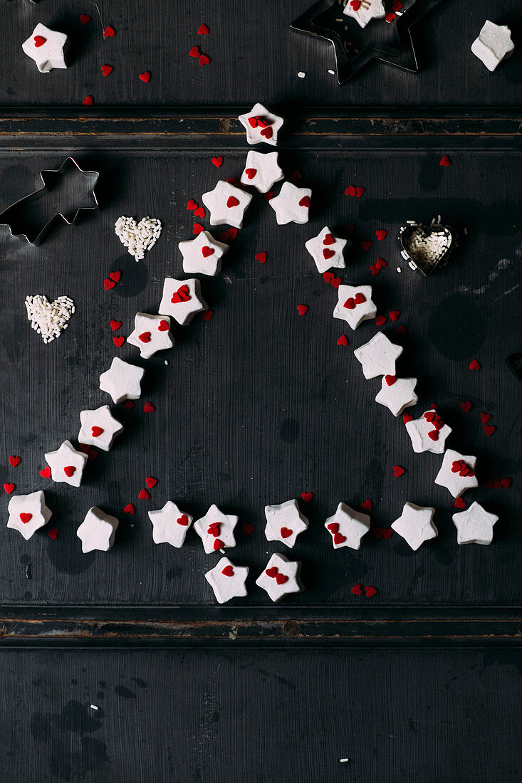 Star-shaped marshmallows and sugar hearts arranged in a Christmas tree shape