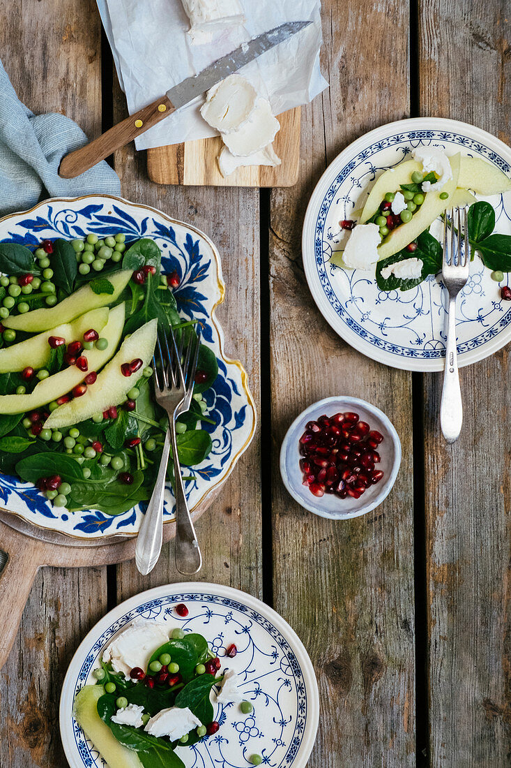 Spinach salad with peas, pears, pomegranate seeds and goat's cheese