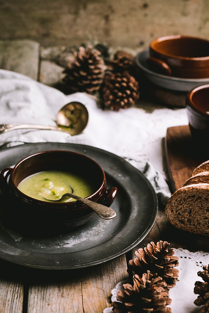 Zucchini soup on a wintery, rustic wooden table