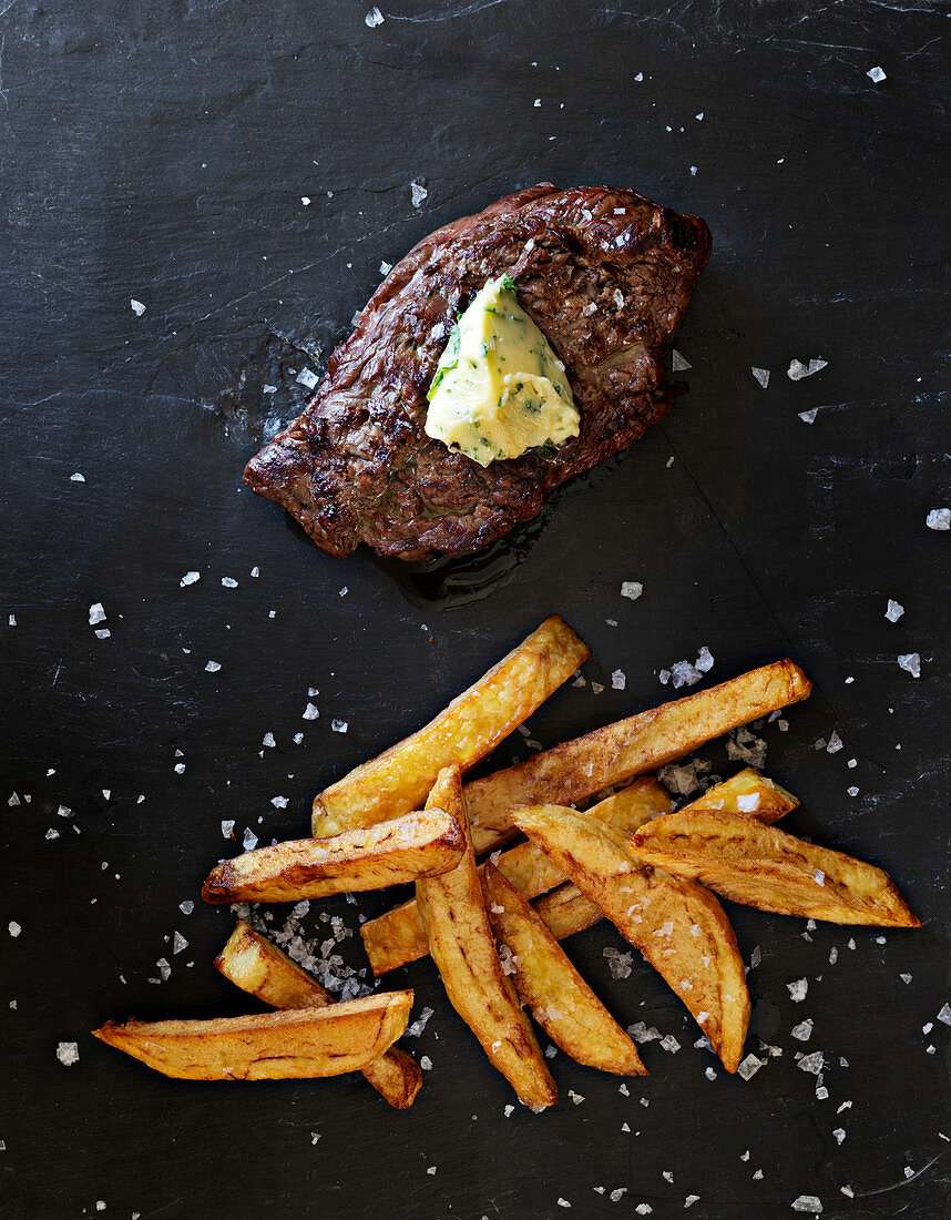 Beef fillet steak with herb butter and chips
