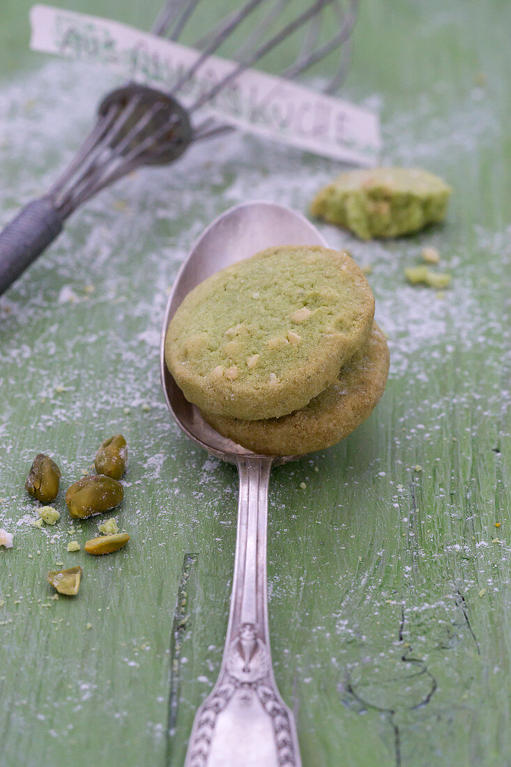 Pistachio biscuits on silver spoon