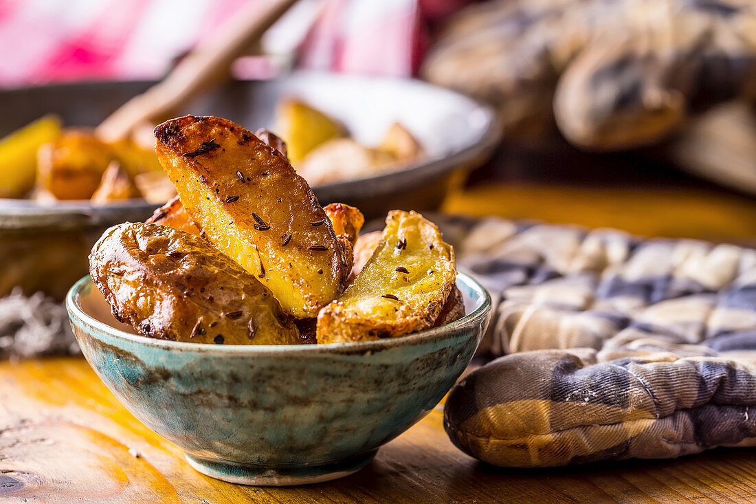 Roasted potato wedges in a small bowl