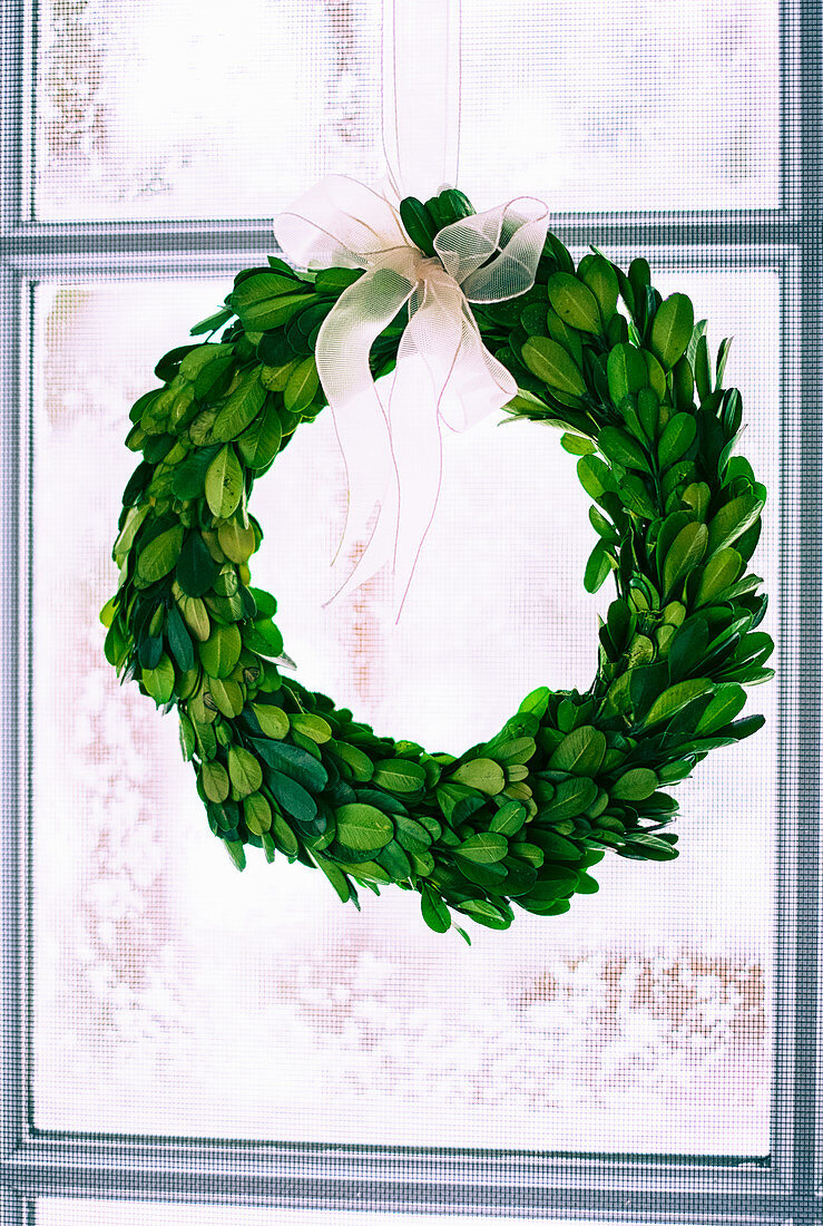 Wreath of box leaves in window