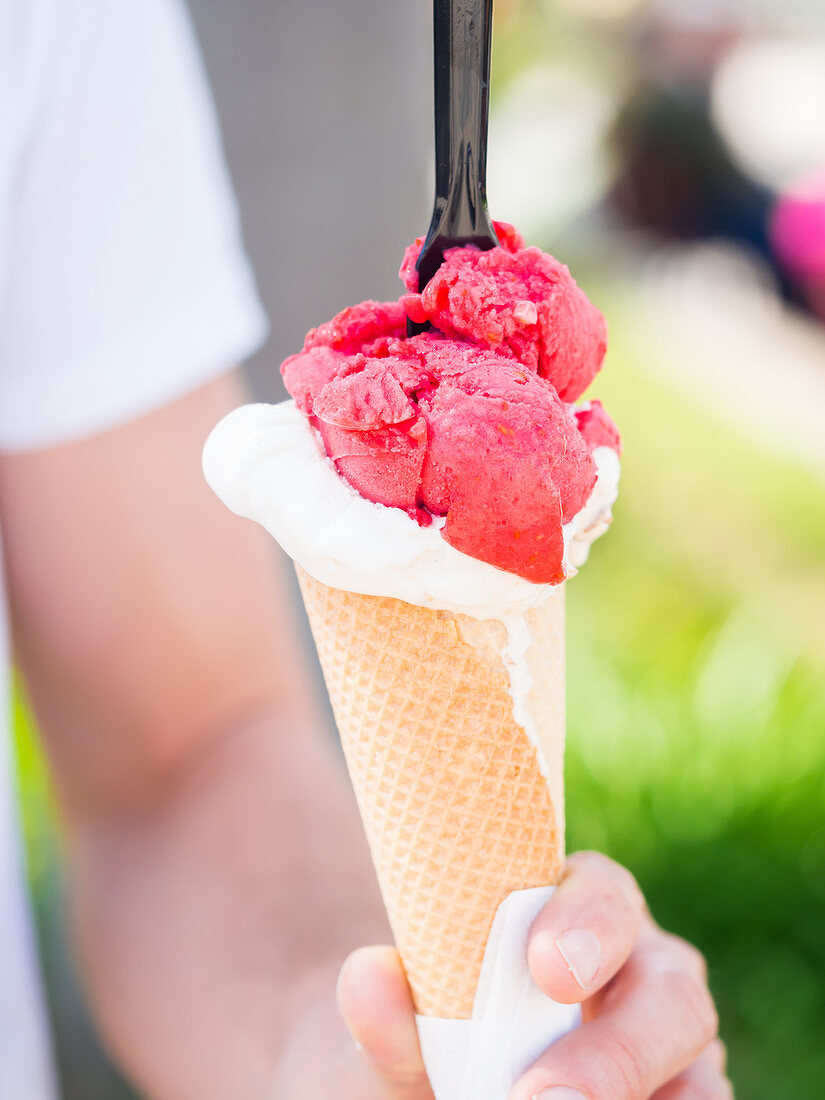 Raspberry and white chocolate ice cream in a cone