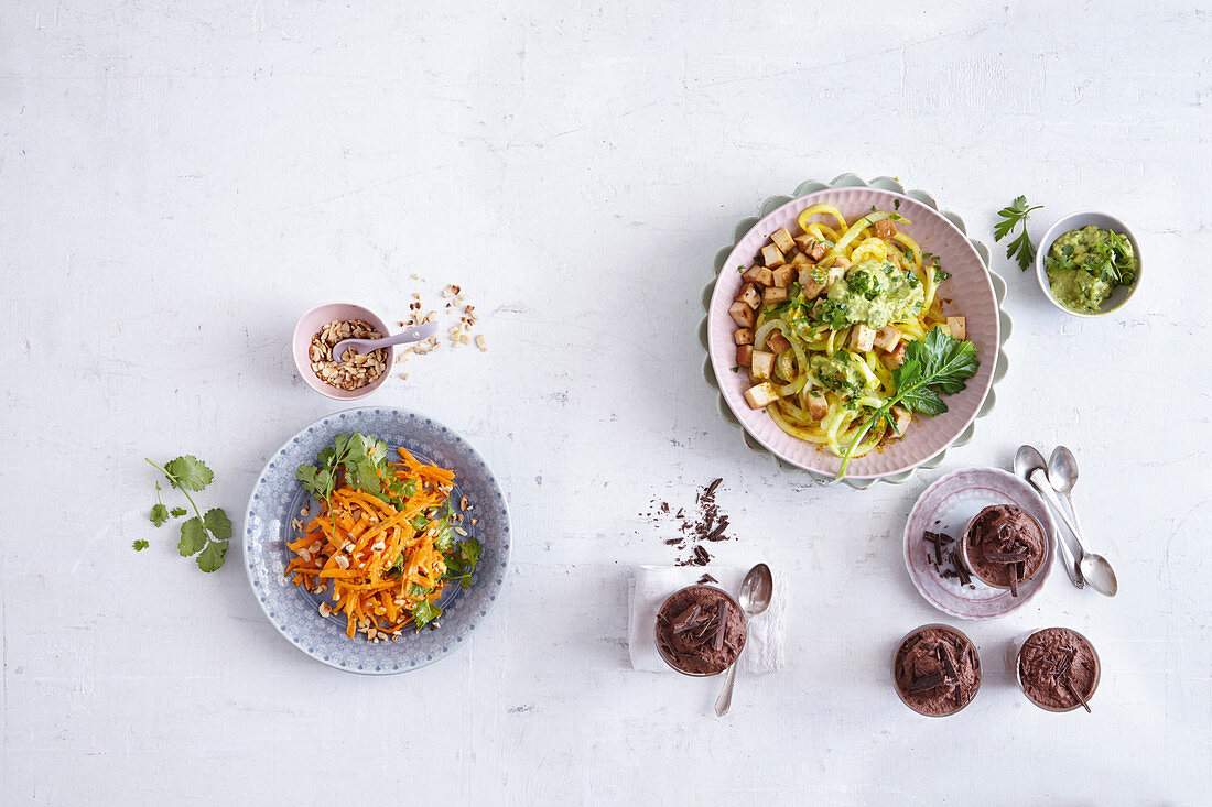 Vegetarian low carb menu with carrot salad, kohlrabi noodles and chocolate mousse