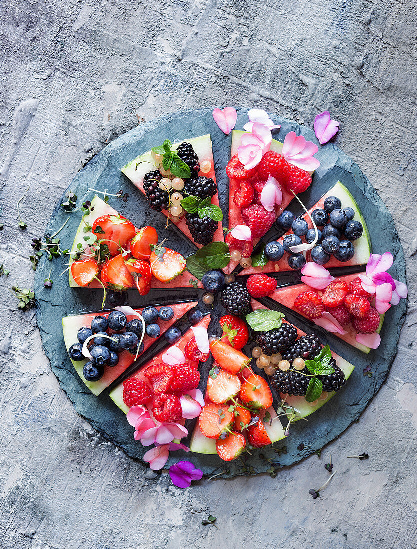 Watermelon pizza with berries and agave syrup