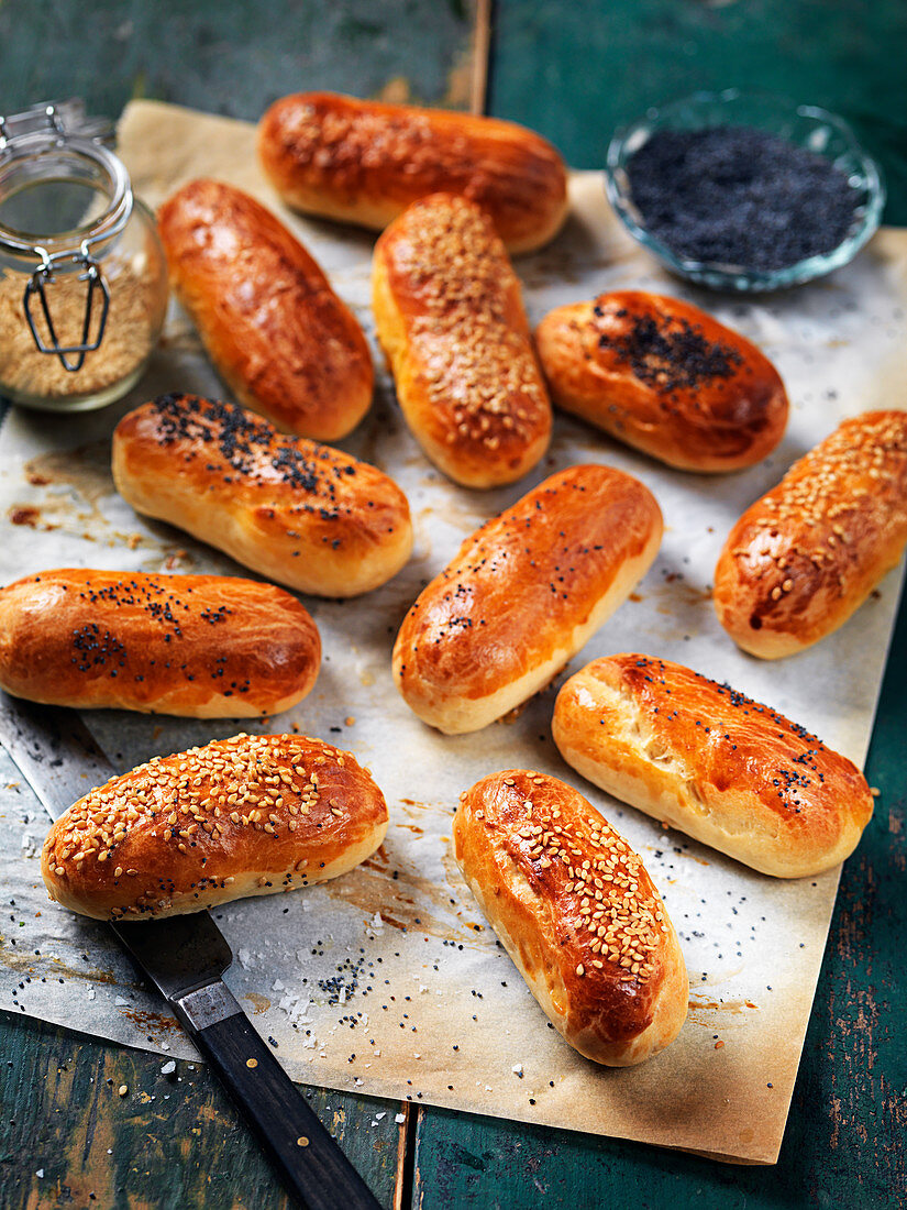 Homemade hot dog rolls with poppy seeds and sesame seeds
