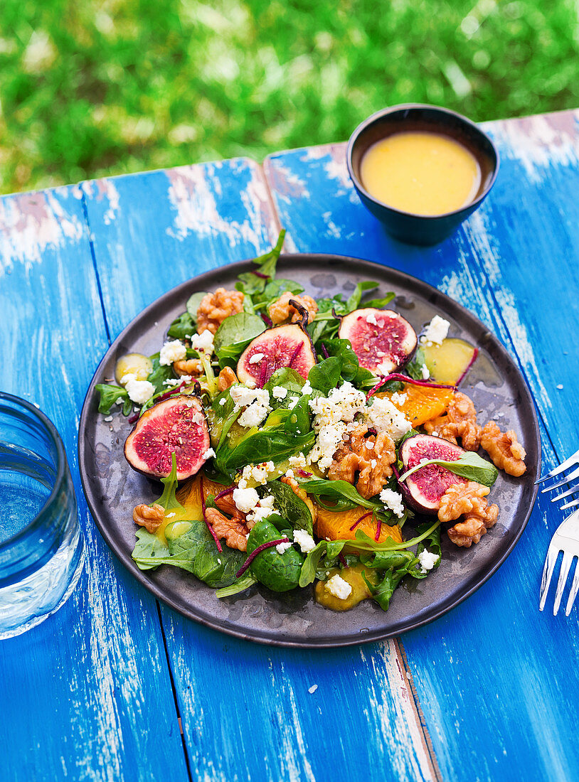 A colourful salad with figs, oranges, walnuts and feta cheese