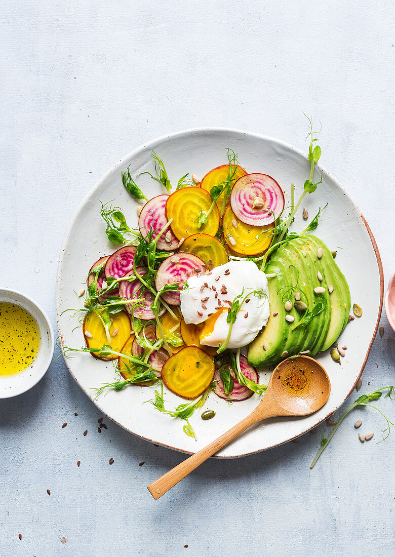 Vegetable salad with avocado and eggs Benedict