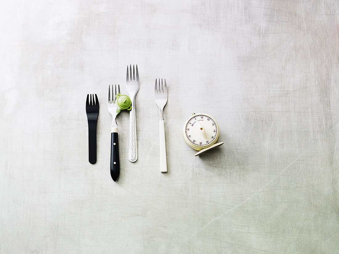 An arrangement of forks and a kitchen timer