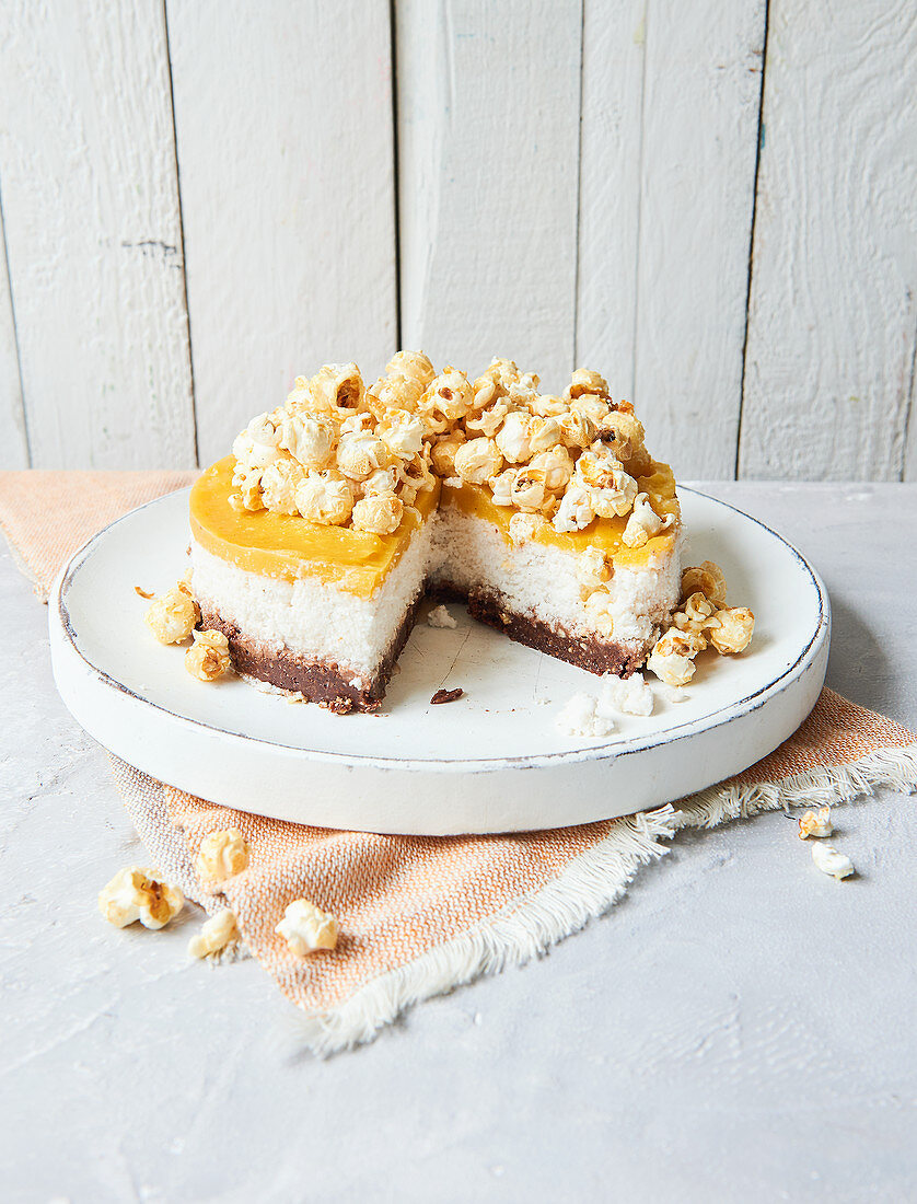 Sugar-free mango and coconut cake with a nut base and a popcorn topping