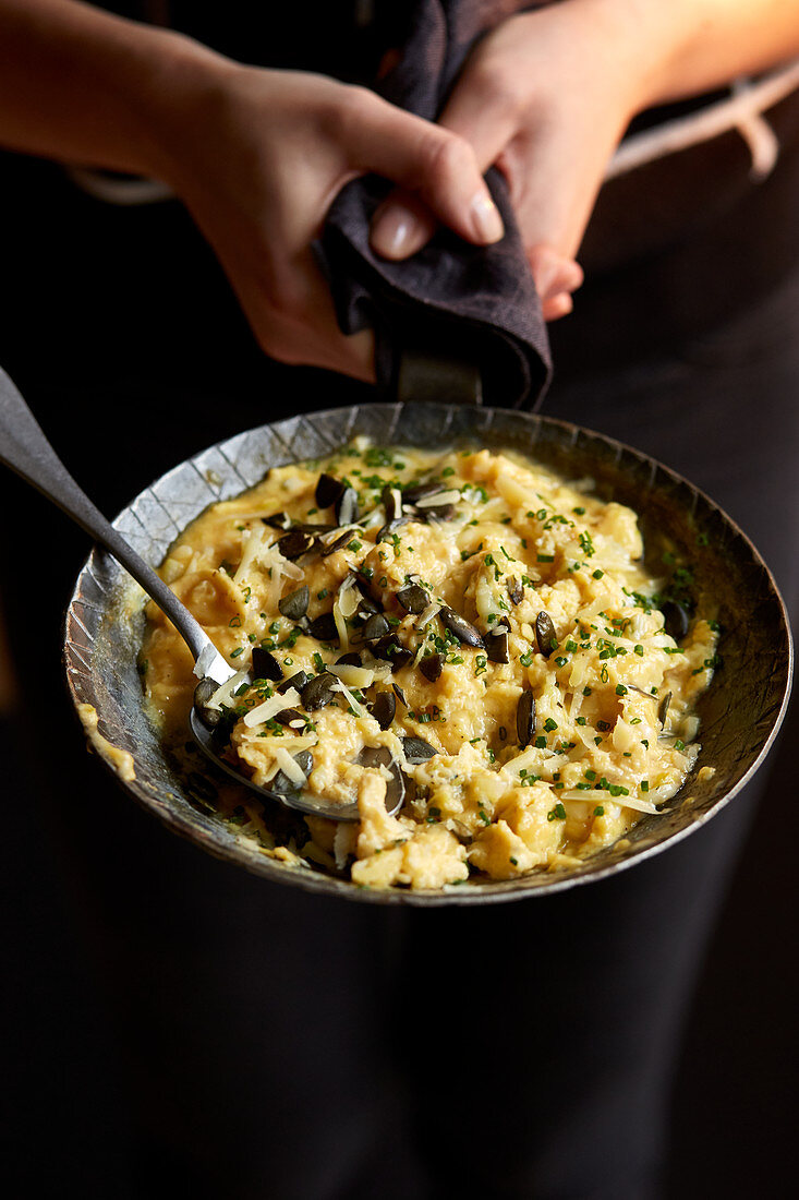 Scrambled eggs with onions, cheese and pumpkin seeds