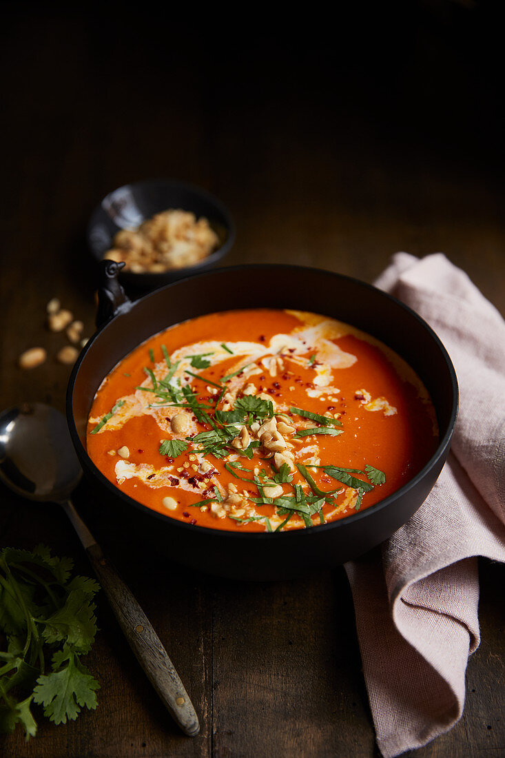 Coconut and tomato soup with peanuts
