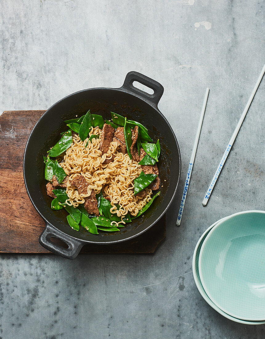 Quick fried oriental mie noodles with beef steak and mange tout