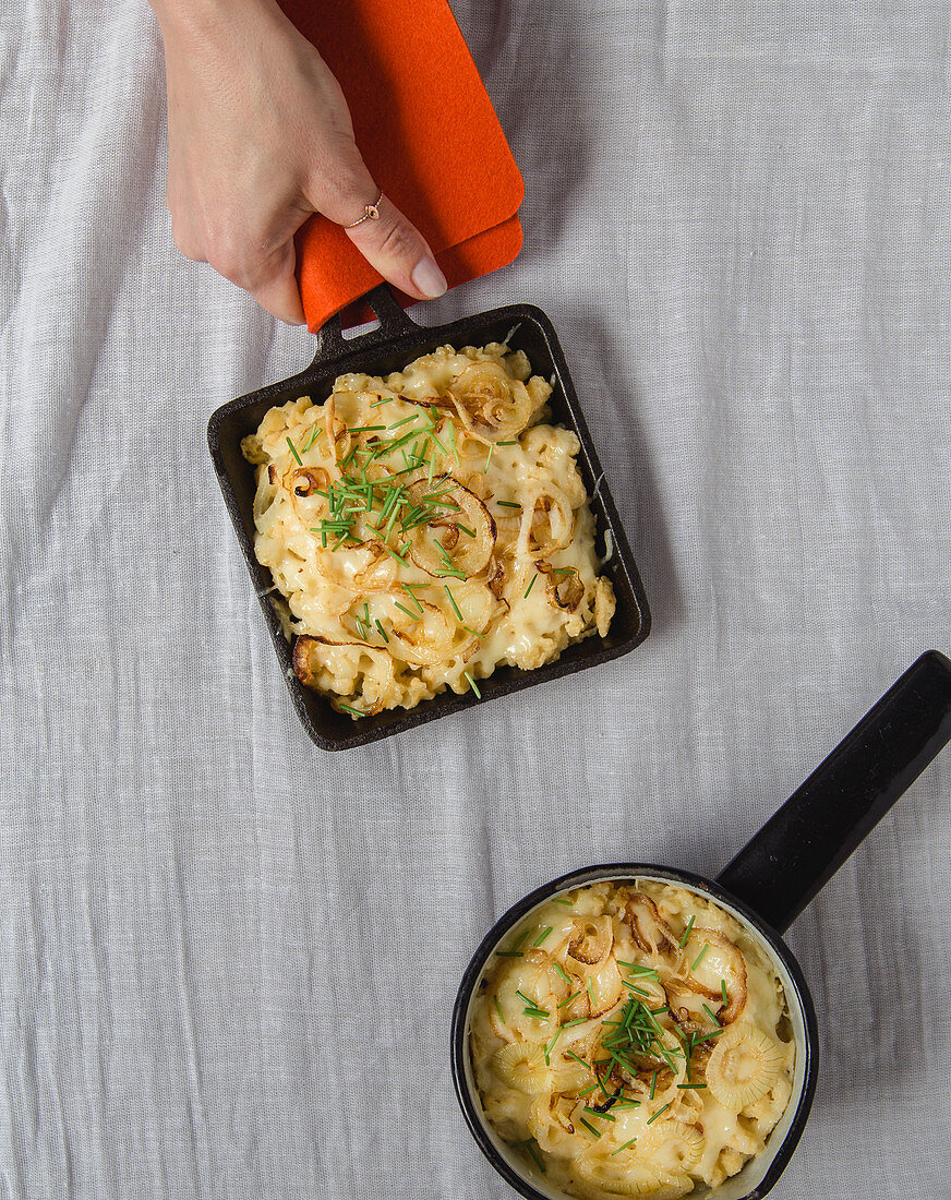 Gratinated cheese pasta from the oven and in a raclette pan