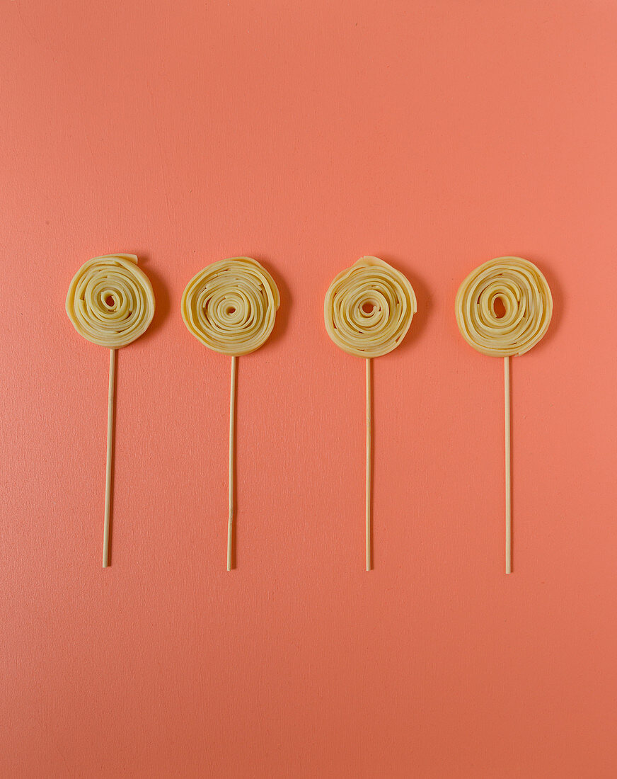 Pasta lollies on a coloured surface
