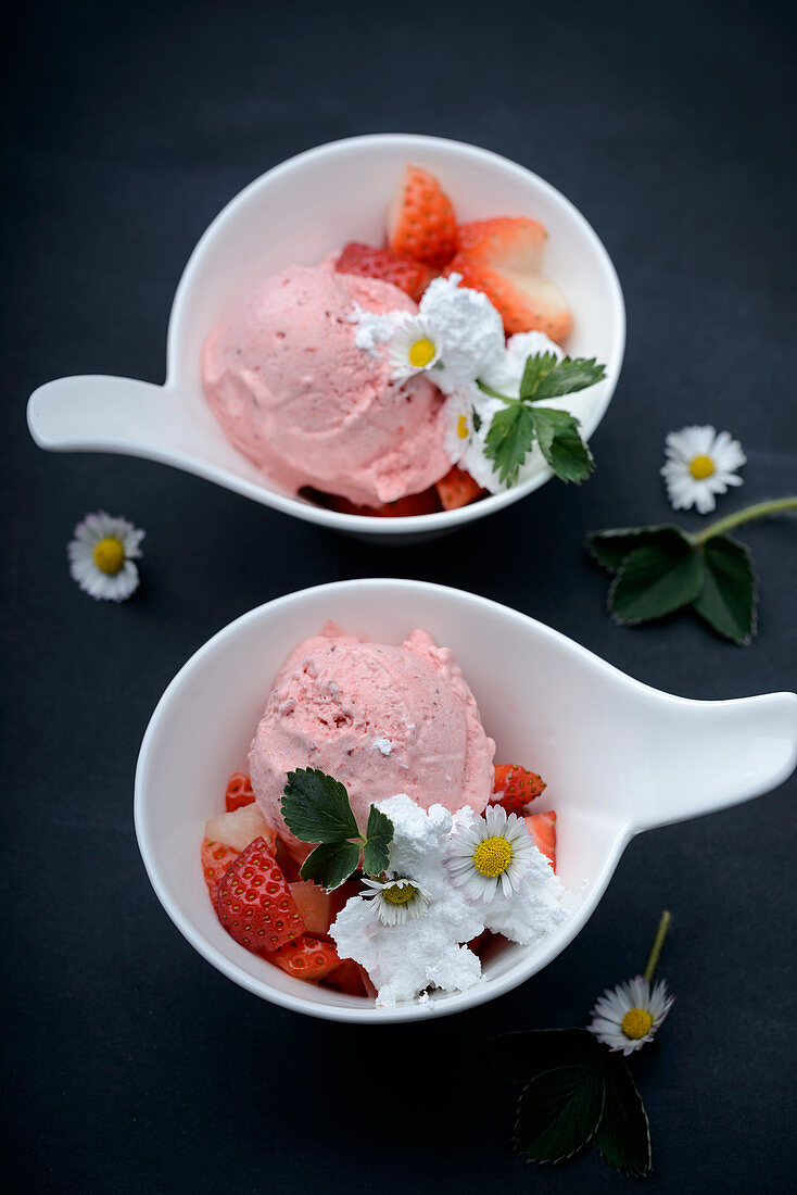 Vegan strawberry ice cream with fresh fruit and whipped soya cream