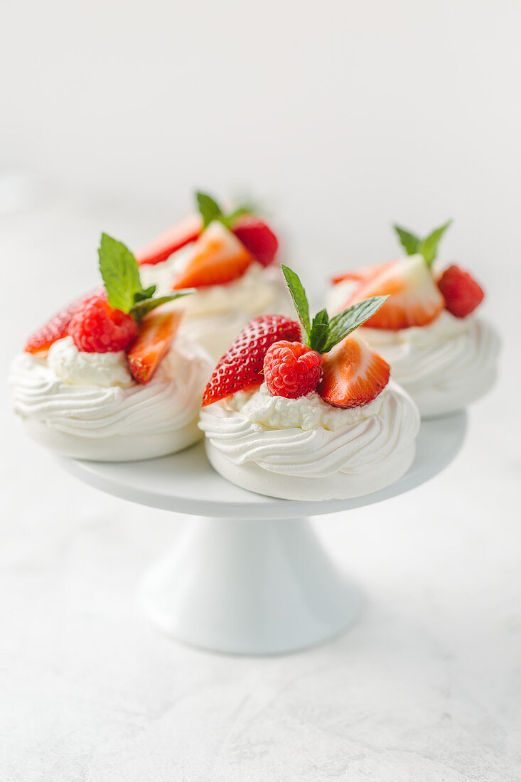 Mini pavlovas with whipped cream and berries