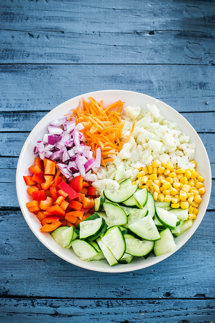 Chopped raw vegetables and sweetcorn in a bowl