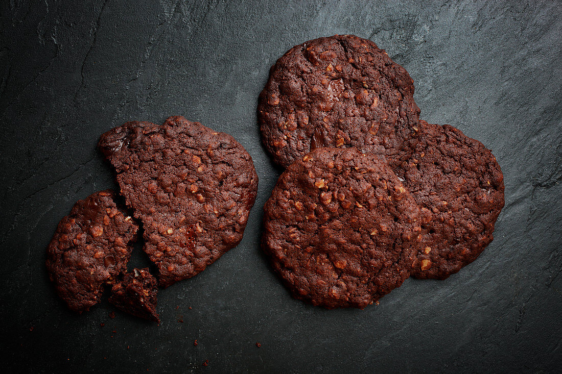 Chocolate biscuits on a dark stone surface