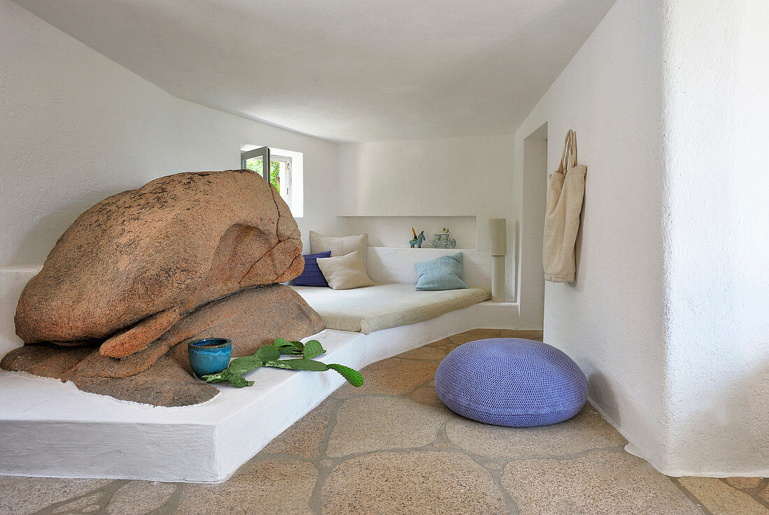 Bed on masonry platform next to boulders