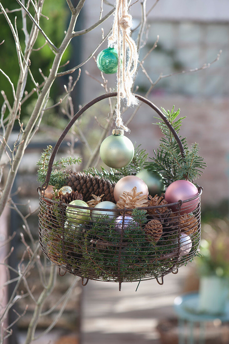 Basket with Christmas baubles and cones