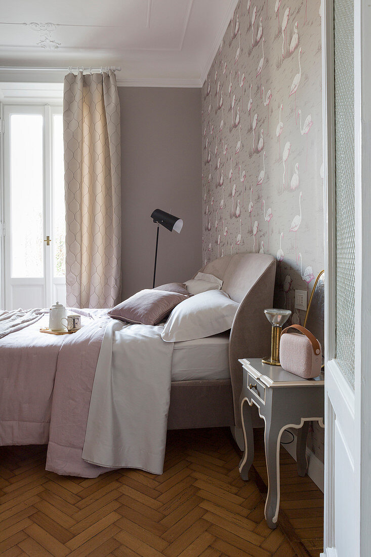 Feminine bedroom in pink and grey with herringbone parquet floor and stucco ceiling