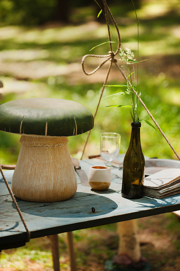 Mushroom ornament on suspended table outdoors