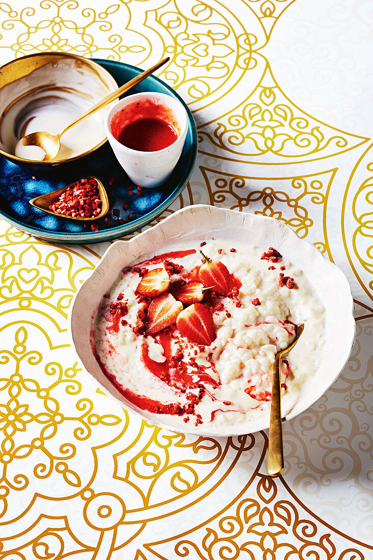 Rich rice pudding with strawberries and cream