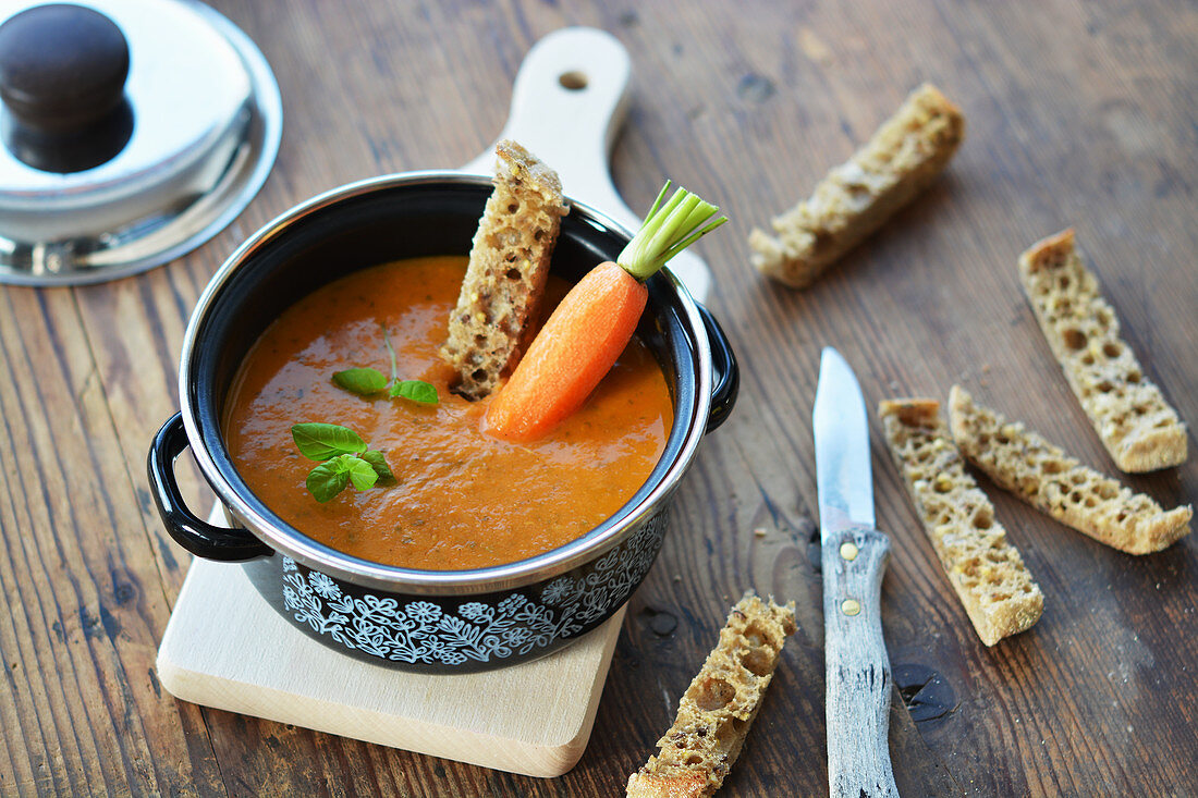 Carrot soup with bread sticks